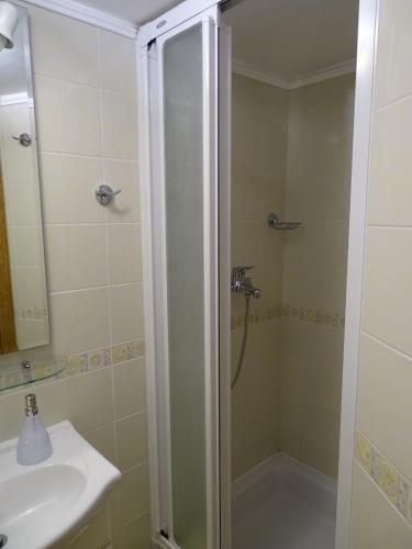 a bathroom with a shower and a sink at Sobe-Apartma in Maribor