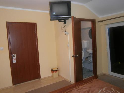 a room with a door and a television on the wall at Vila Patria in Podgorica