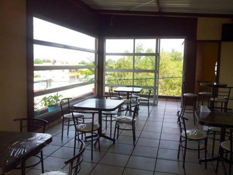 a restaurant with tables and chairs and a large window at HOTEL MONTALVO in Tezontepec de Aldama