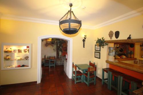 a dining room with a table and a chandelier at Hotel Boutique Vieja Cuba in Quito