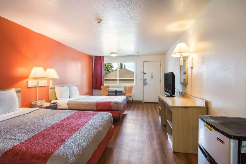 a hotel room with two beds and a flat screen tv at Motel 6-Vancouver, WA in Vancouver