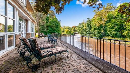 a porch with two benches and a fence at Best Western Plus The Inn & Suites at the Falls in Poughkeepsie