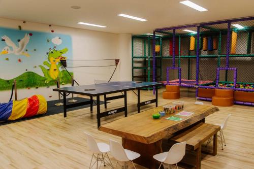 a room with a ping pong table and chairs at Grand Hyatt Rio de Janeiro in Rio de Janeiro