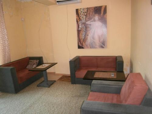 a living room with two couches and a table at Vila Patria in Podgorica