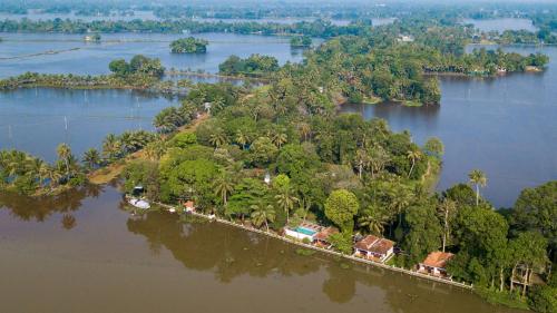 an island in the middle of a river at Warmth Lake Haven in Alleppey