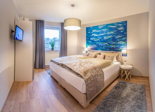 a bedroom with a large bed with a painting on the wall at Schiller-Quartier 6 in Bremerhaven