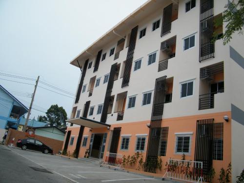 a building with black barred windows on a street at Fundee 1 Mansion in Ubon Ratchathani