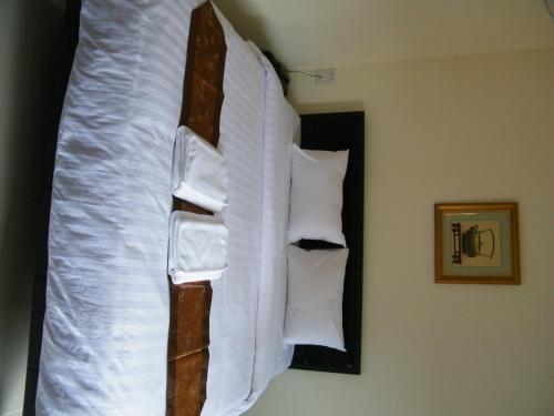 a bedroom with a bed with pillows on it at Fundee 1 Mansion in Ubon Ratchathani