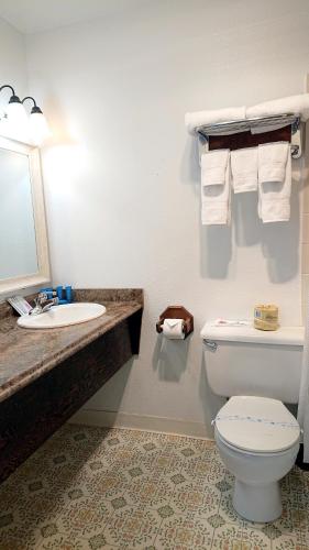 a bathroom with a toilet and a sink at Silver Sands in Rockaway Beach