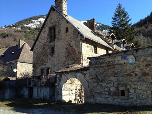 an old stone building with a chimney on top of it at Au Fil des Saisons in Les Cotes de Corps