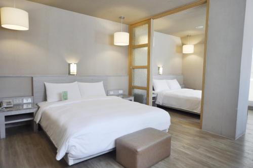 Cama o camas de una habitación en Kindness Hotel - Hanshen