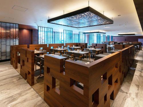 a restaurant with tables and chairs in a room at Hakodate Kokusai Hotel in Hakodate