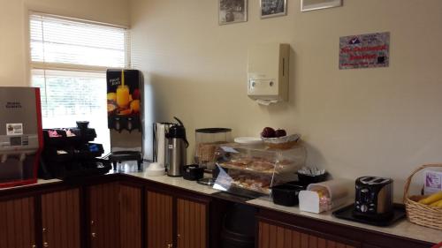 a kitchen with a counter top with a counter top at Americas Best Value Inn - Palmyra/Hershey in Palmyra