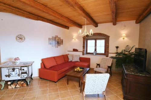 a living room with a red couch and a table at Holiday Home Ivana in Pasjak