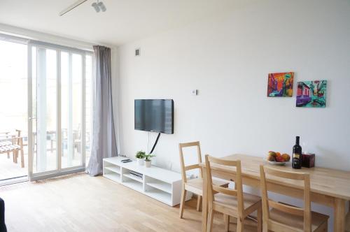 a white living room with a table and a dining room at Suite Prague Apartment -Duplex, up to 4people in Prague