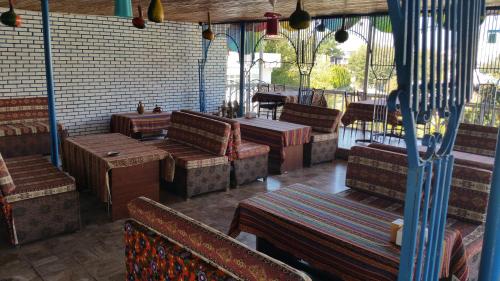 a restaurant with benches and tables in a room at Mustafa Hotel in Pamukkale