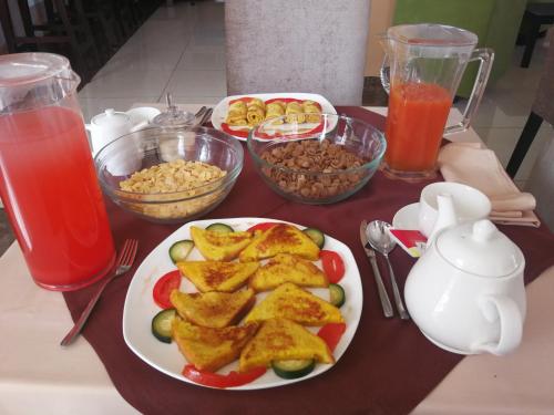 a table with a plate of fried food and drinks at Ye Afoli International Hotel in Addis Ababa