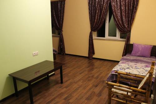 a bedroom with a bed and a table and a window at Sevan Backstage Garden in Sevan