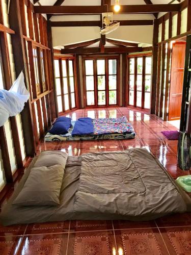 a large bed is laying on the floor of a room at Grandma's House in Nakhon Nayok