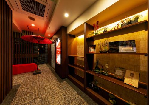 a hallway with a red umbrella in a building at HOTEL Eldia Japanese Modern (Adult Only) in Gyōda