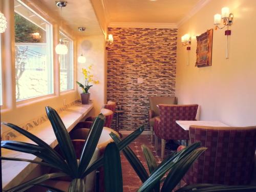 a restaurant with chairs and a brick wall at The Vendange Carmel Inn & Suites in Carmel