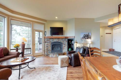a living room with a couch and a fireplace at Ponderosa Views in Bend