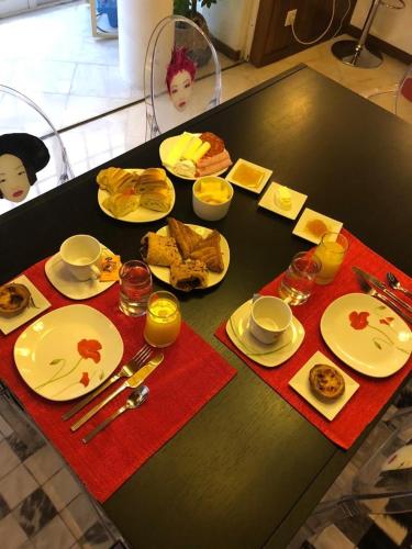 een zwarte tafel met borden met voedsel erop bij Villa Monaco in Faro