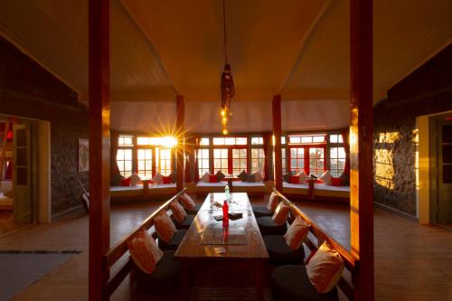 a large room with a long table and chairs at Zostel Kodaikanal in Kodaikānāl