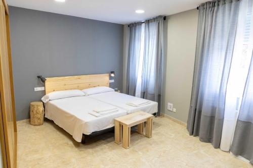 a bedroom with a bed and a table in it at Alda Estella Hostel in Estella