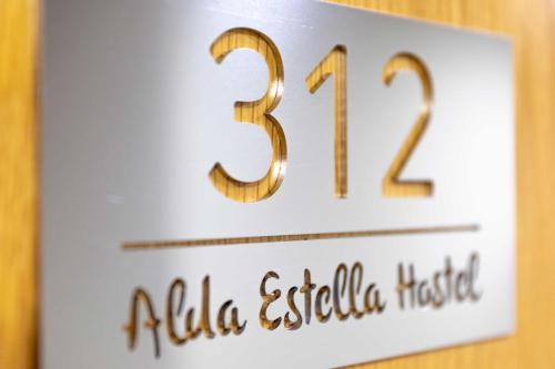 a sign that says ala established hotel on a wall at Alda Estella Hostel in Estella