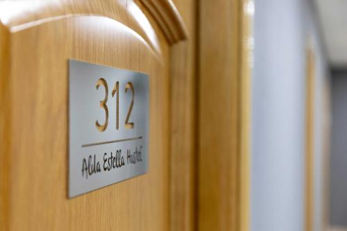 a wooden door with a sign on it at Alda Estella Hostel in Estella