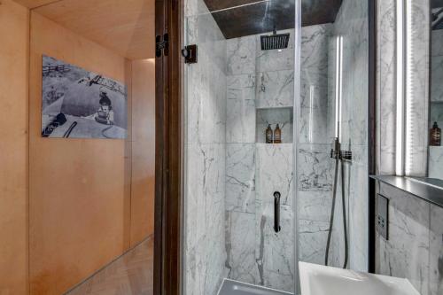 a bathroom with a shower with a glass door at Stow Away Waterloo in London