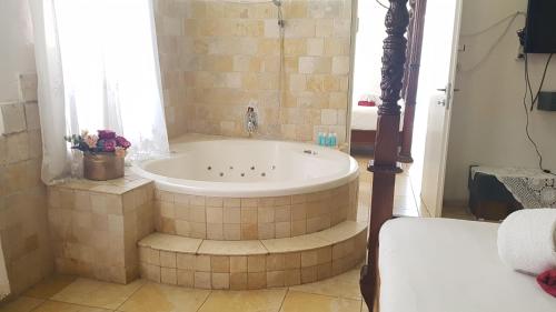 a bath tub in a bathroom with a window at Lake Mansion in Tiberias
