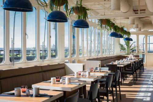 a row of tables in a restaurant with blue lights at Only YOU Hotel Atocha in Madrid