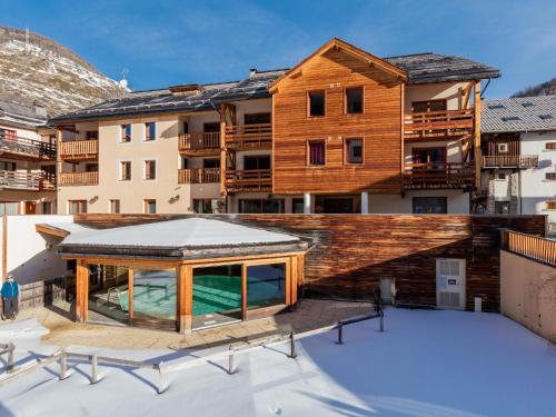 a view of a building from the roof of a building at Madame Vacances Les Balcons Du Viso in Abriès
