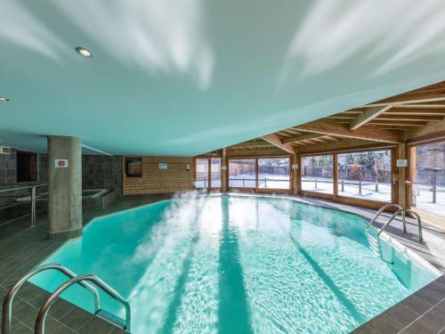 a large indoor swimming pool in a building at Noemys Balcons Du Viso in Abriès
