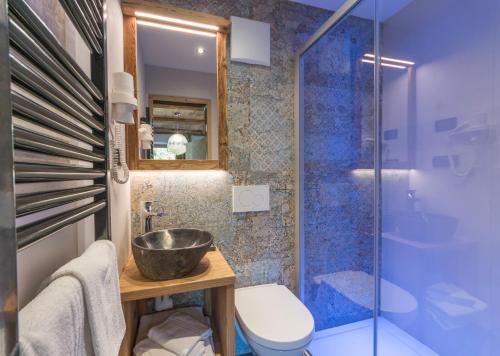 a bathroom with a sink and a toilet and a shower at Alpine Residence Villa Adler in San Vigilio Di Marebbe