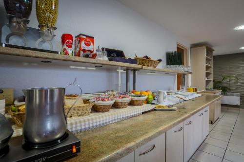 a kitchen with a counter with baskets of food at Adams Hotel in Metz