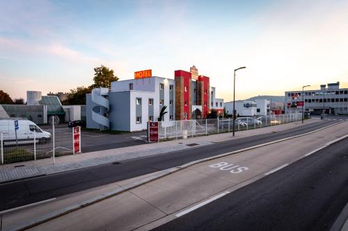 an empty road in a city with buildings at Adams Hotel in Metz