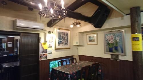 a dining room with a bench and pictures on the wall at Live Cafe Hisui no Umi in Itoigawa