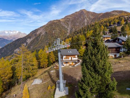 an aerial view of a house in the mountains at Chalet Bärgsunna in Rosswald