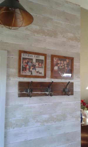 a reclaimed wood wall with pictures on it at Garden View Apartment in Salcombe
