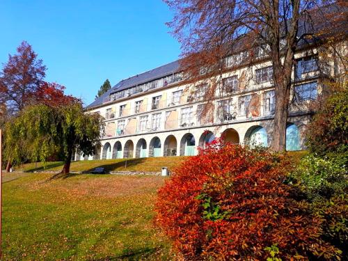 a large building with red bushes in front of it at Sonnenhof in Bad Elster