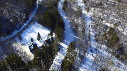 an overhead view of a snow covered forest with tents at Ski in/out Spruce Glen Townhomes on Great Eastern Trail in Killington