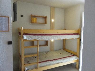a small room with two bunk beds in it at LE Hameau 001 in Manigod