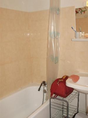 une salle de bain avec une baignoire, un lavabo et un sac à main rouge dans l'établissement MONT BLANC Soleil C19, à Manigod