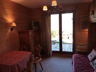 a bedroom with two beds and a sliding glass door at MONT BLANC Soleil B-4 in Manigod