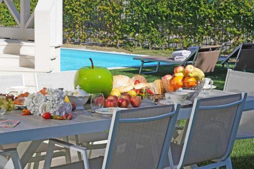 a table with a bunch of fruits and vegetables on it at Villa Sabine: New Modern villa with Private pool in Toscolano Maderno