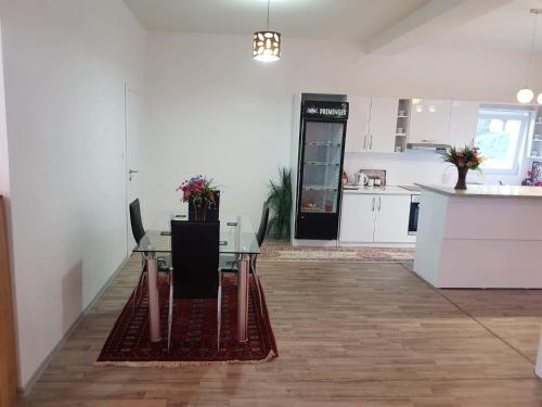an empty room with a table and a kitchen at Vinac guest house in Jajce