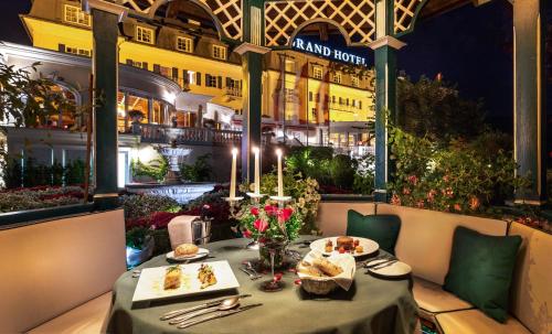 a table at a restaurant with food on it at Grand Hotel Zell am See in Zell am See